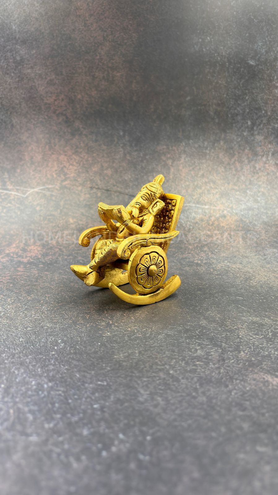 Brass Ganesh in rocking chair