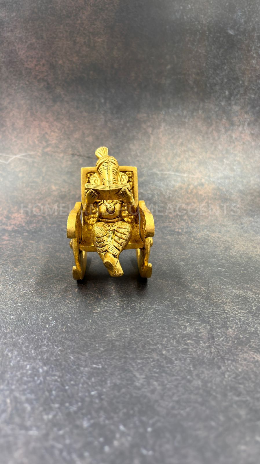 Brass Ganesh in rocking chair
