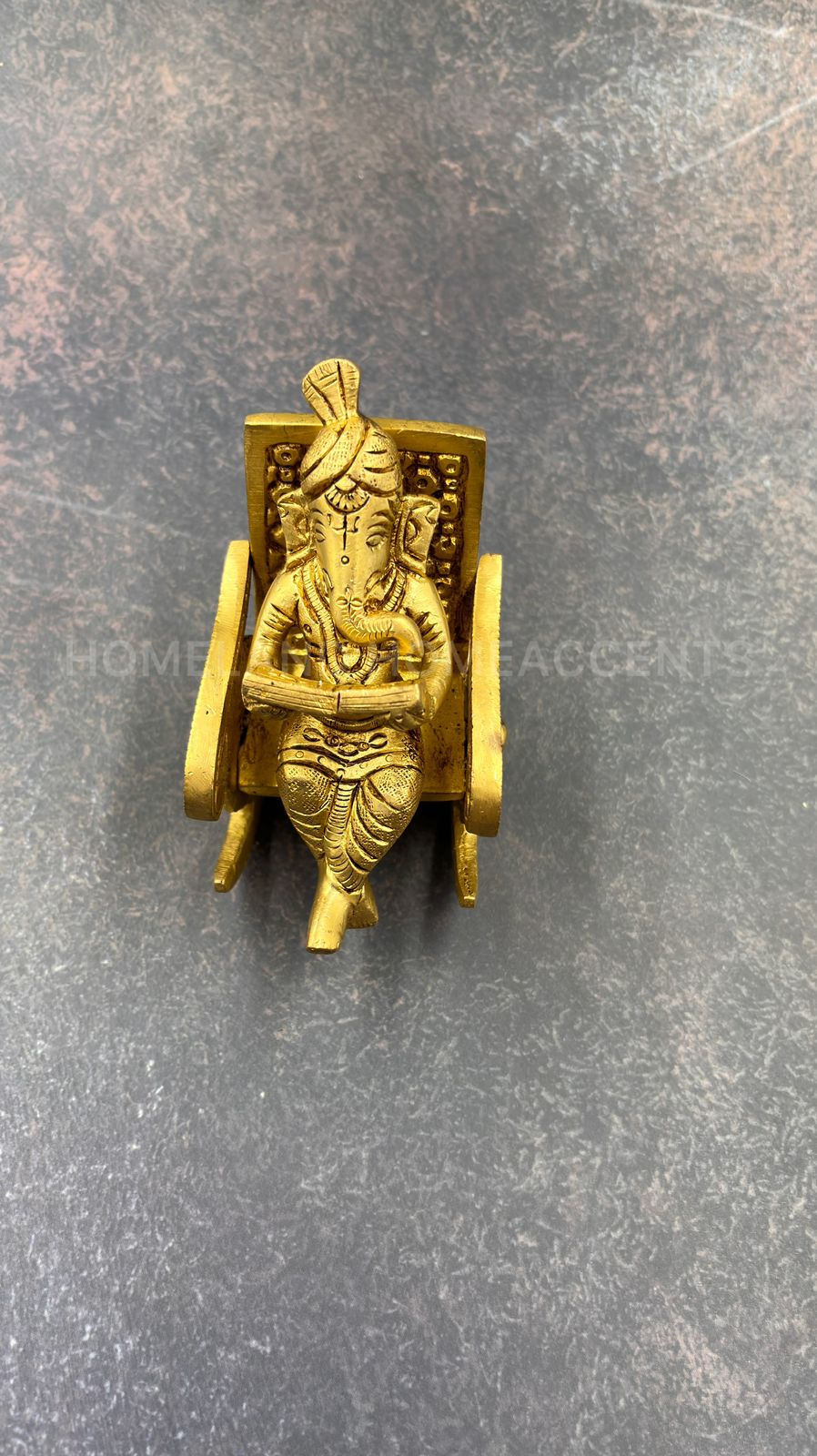 Brass Ganesh in rocking chair
