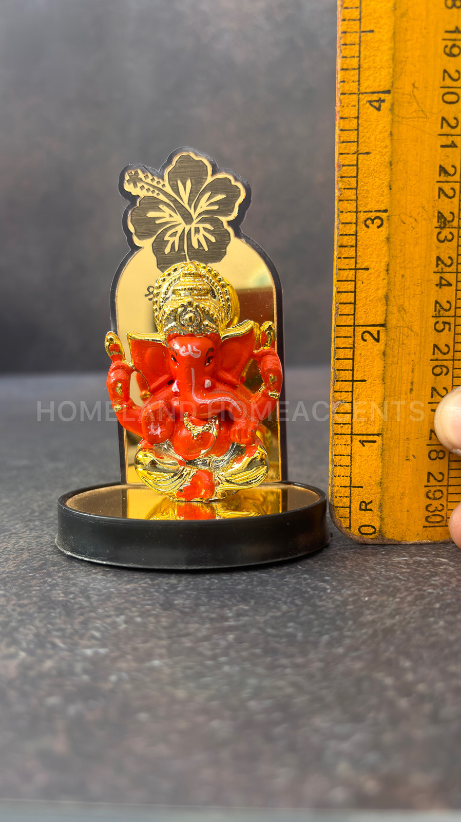Vibrant Orange Ganesh Idol with Hibiscus Backdrop